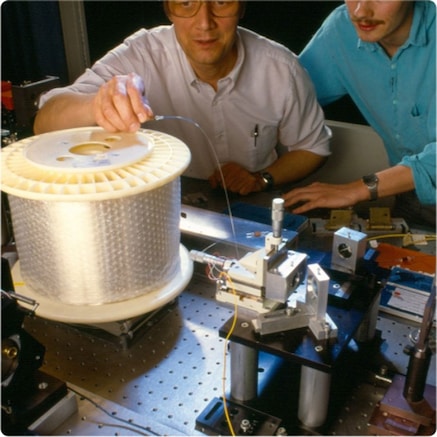 Two engineers conducting solition test on fiber optic cable