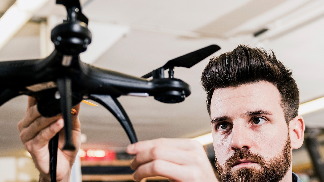 Drone operator makes adjustments to drone