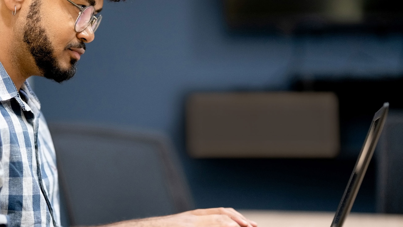 Man typing on laptop