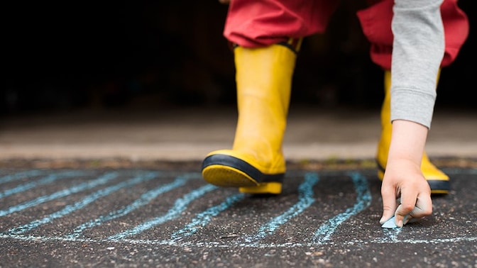 A child drawing with chalk