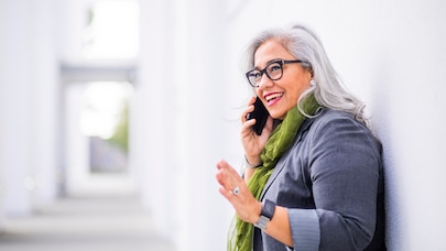 A woman with glasses talking on a mobile phone