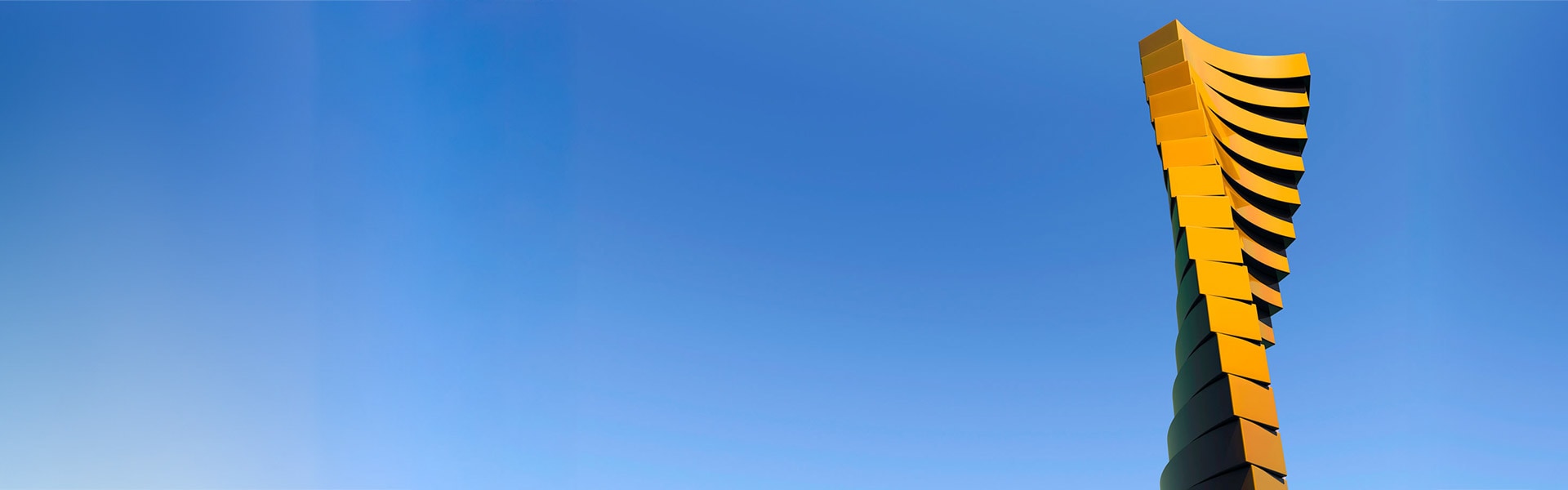 Twisiting tower against a blue sky background